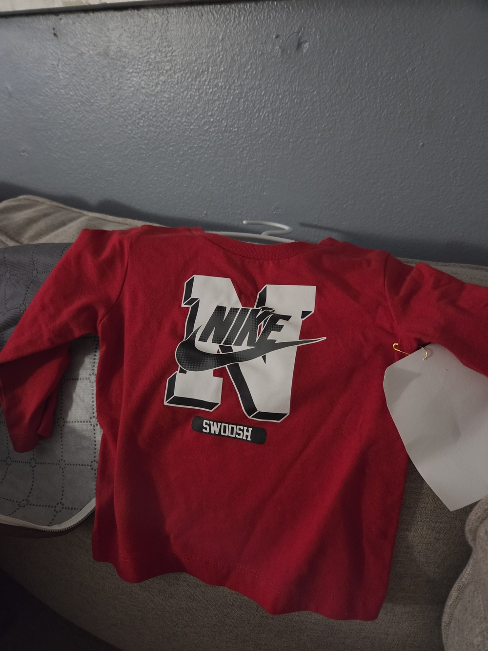 Nike Red Long-Sleeve Kids Top with Bold White Swoosh Graphic